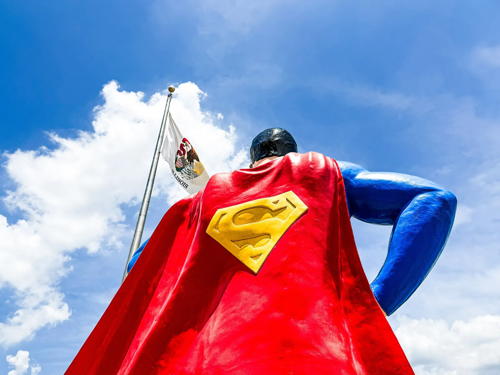 The giant Superman statue in Metropolis, Illinois, photographed from below against a blue sky